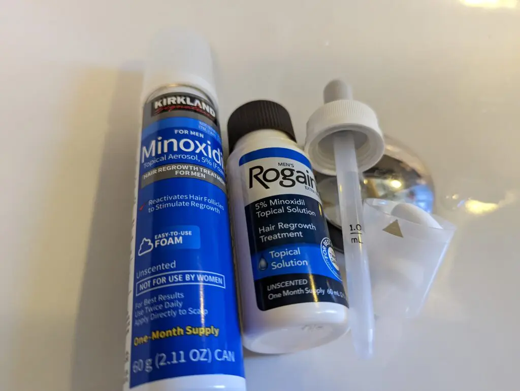 Kirkland Minoxidil 生髮慕斯與生髮水質地對比實測：左手滴管呈現黃色油膩的液體（含丙二醇），右手掌心呈現白色清爽綿密的慕斯泡沫。展示兩者在黏膩度與乾燥速度上的巨大差異。